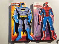 Batman and Spider-Man die-cut board books side by side