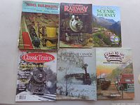 Six rail and model railroading publications displayed in two rows