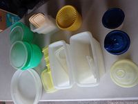 Group shot of entire lot showing assorted containers and lids