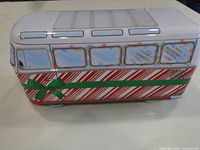 Left side view of VW bus-shaped tin showing candy-cane design