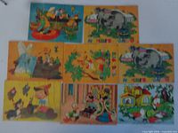 Eight Disney-themed puzzle boards laid out for view