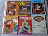 Six wood-carving books laid out on table