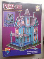 Front of Puzz-3D Victorian Mansion puzzle box showing artwork and piece count
