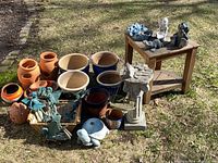 Group view of all planters, statues, birdbath and corner table on lawn
