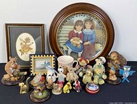 Full lot overview showing plate, prints, mug, and figurines