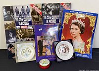 Group shot showing all books, two boxed plates and trinket tin