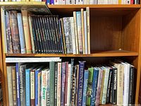 Two-shelf view of assorted Canadian, British history, nature and travel books