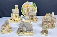 Group shot showing seven cottages and decorative plate
