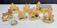 Eight miniature cottages laid out for size and style overview