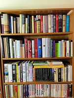 Full view of three-shelf bookcase densely packed with books