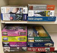 Shelf view showing multiple Eurographics Fine Art boxes and Adelie Penguins 850-piece puzzle