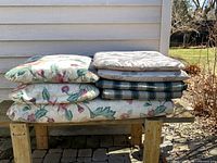 Stack of six cushions showing patterns and thickness