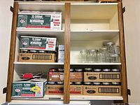 Cupboard shelves with boxed Bernardin and Golden Harvest jars, loose jars visible