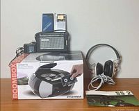 Group shot showing boombox box, radios, headphones, manual