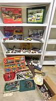 Shelf with puzzles, train models, buildings, track, Timpo box and loose parts