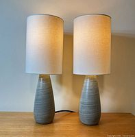 Both lamps illuminated on wood surface