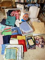 Overview of fabrics, batting packages, pillow forms, stencil, and quilt blocks