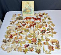 Puzzle pieces spread out with box for scale