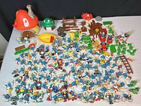 Wide shot of all figurines, houses, accessories spread on table