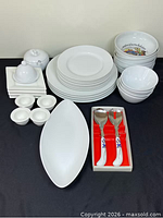 All items grouped showing plates, bowls, platter, serving spoons, lidded pieces