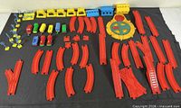 All components laid out: red tracks, rolling stock, turntable, buildings, signs