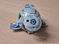 Bakugan partially opened showing side fins and emblem