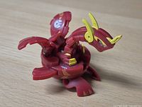 Bakugan figure opened in dragon form showing wings, legs and markings