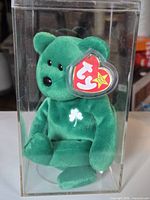 Front view of Erin Beanie Baby in case showing tag and shamrock embroidery