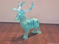 Front left view of translucent blue glitter stag figure