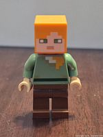 Front view of assembled LEGO Alex minifigure showing head, torso, legs