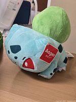 Front-side view of Bulbasaur plush with Aoger tag visible