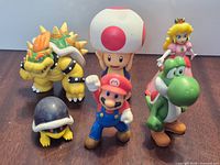 Group shot of all six Super Mario figurines on tabletop