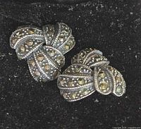 Front view of marcasite bow earrings in velvet box