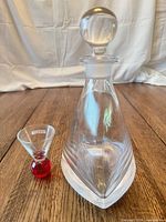 Decanter with stopper and Smirnoff shot glass side by side