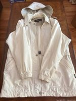 Raincoat front view showing hood, closure, pockets