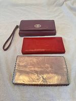 Front view of three wallets showing colors and exterior condition