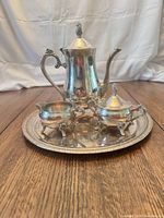 Full view of the four-piece silver-plated tea/coffee service on tray