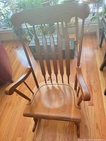 Front view of light brown solid wood Windsor rocking chair