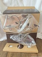 Tree-shaped stand partially assembled with box and packaging visible