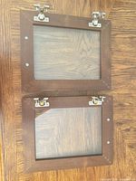 Both cabinet doors front view showing wood frames, glass panels, hinges