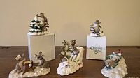 Group photo of five Charming Tails figurines with two original boxes