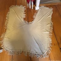 Full view of shawl laid flat showing U shape and fringe