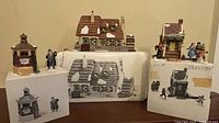 Group shot of all three buildings, four figures and boxes