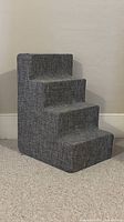 Front angled view showing four steps and upholstery
