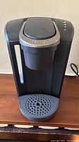 Front view showing entire Keurig brewer, water reservoir and drip tray
