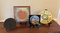 Group shot of four trivets on easels