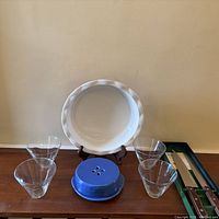 Group view of platter on stand, blue brie baker, four glass bowls, knife box