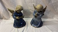 Front view of both ceramic angel figurines
