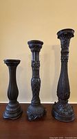 Front view of all three pedestal candle holders