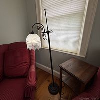 Full view of floor lamp next to sofa and table